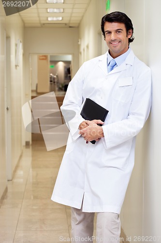Image of Happy Male Doctor Holding Book
