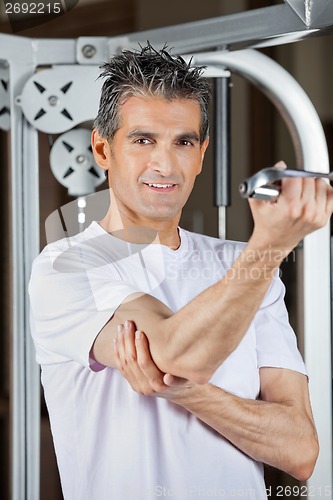 Image of Mature Man Working Out In Fitness Center