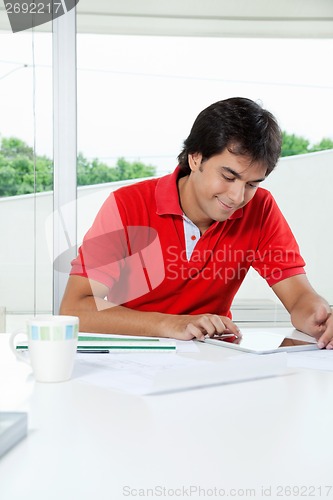 Image of Young Man Using Digital Tablet