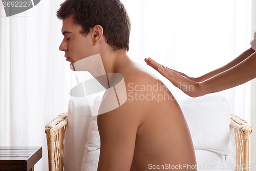 Image of Hand Massaging Man's Back