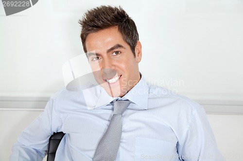 Image of Young Businessman Relaxing In Office