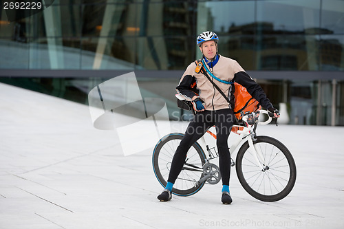 Image of Male Cyclist With Courier Bag Sitting On Bicycle