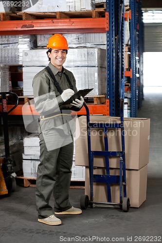 Image of Male Supervisor Writing On Clipboard