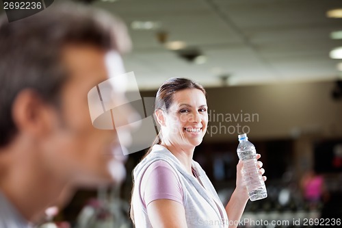 Image of Woman Holding Bottle Of Water At Health Club