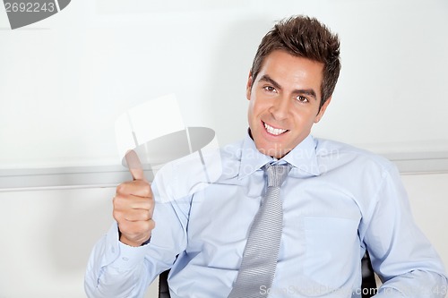 Image of Young Businessman Gesturing Thumbs Up