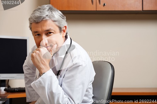 Image of Male Doctor With Hand On Chin