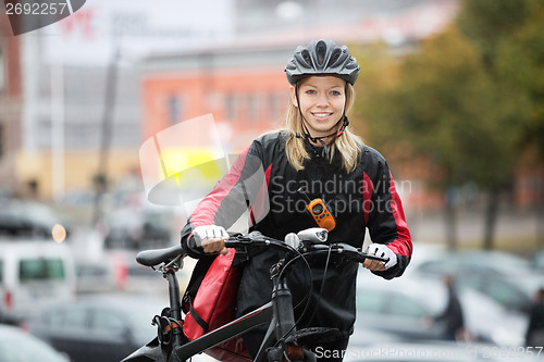 Image of Female Cyclist With Courier Bag On Street