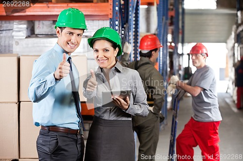 Image of Supervisors Gesturing Thumbs Up At Warehouse