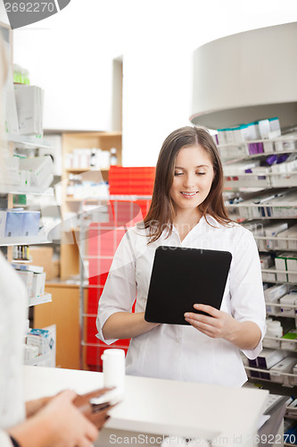 Image of Pharmacist Helping Customer with Digital Tablet