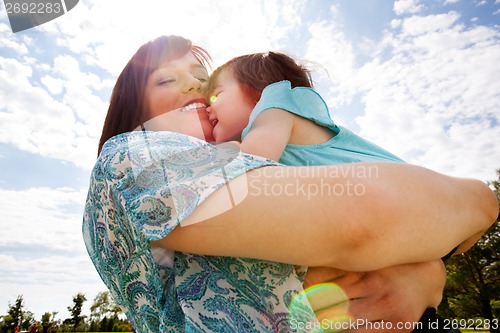 Image of Mother and Daughter Hugging Outdoors