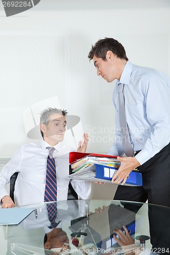 Image of Businessmen Overwhelmed By Load Of Work