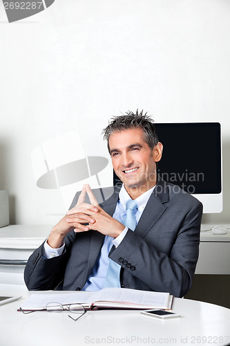 Image of Thoughtful Happy Businessman At Desk