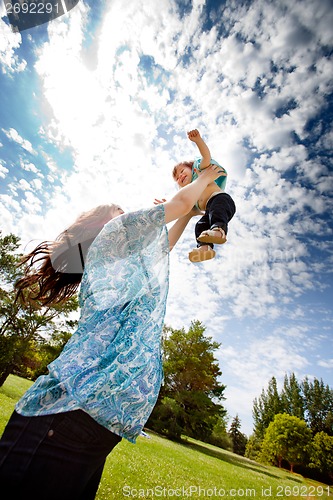 Image of Mother Throwing Daughter in Air