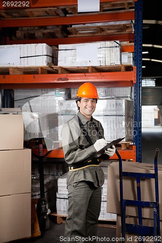 Image of Supervisor Writing On Clipboard At Warehouse