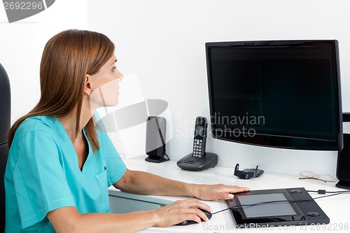 Image of Female Dentist Using Computer