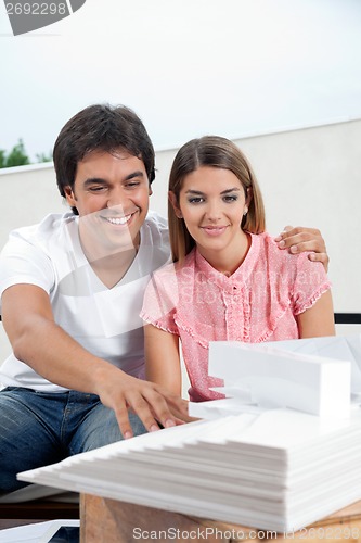 Image of Couple Looking At Model Structure