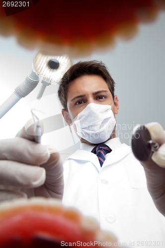 Image of Dentist Examining Patient's Mouth