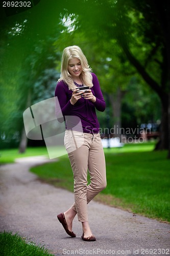 Image of Woman Using Cell Phone in Park