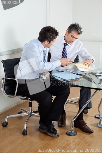 Image of Businessmen Discussing Paperwork In Office