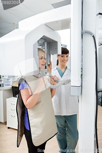 Image of Female Dentist With Patient Getting Her Teeth X-Rayed At Clinic