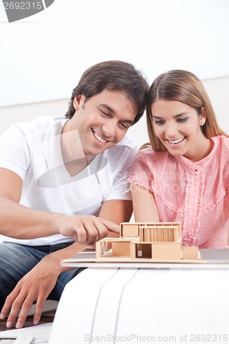 Image of Couple Looking at House Model