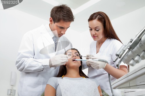 Image of Dentist And Nurse Examining Patient's Teeth