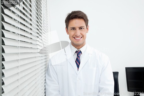 Image of Happy Dentist Standing In Clinic