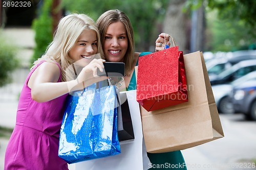 Image of Shopping Women taking Photograph