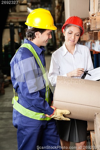 Image of Supervisor And Foreman Inspecting Stock