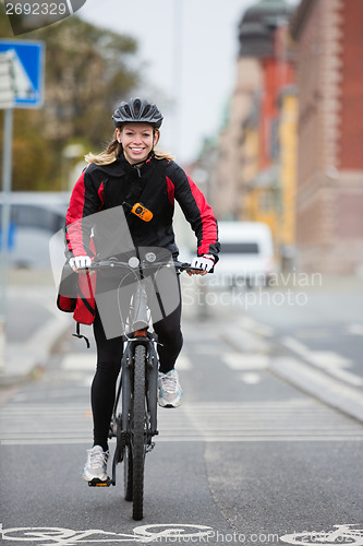 Image of Female Cyclist With Courier Delivery Bag