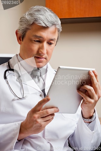 Image of Doctor Looking At Digital Tablet