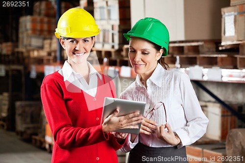 Image of Female Supervisor With Colleague At Warehouse