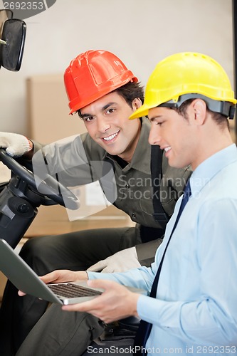 Image of Forklift Driver With Supervisor Using Laptop