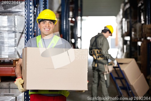 Image of Mid Adult Foreman With Cardboard Box At Warehouse