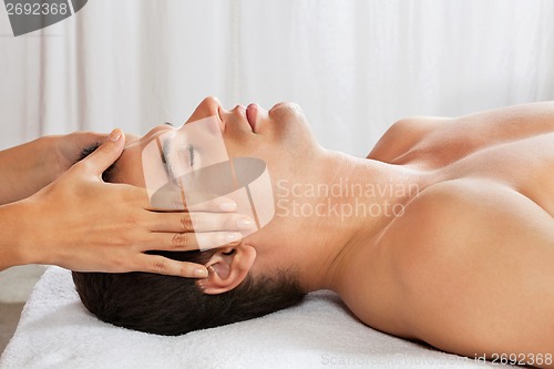 Image of Man Receiving Head Massage At Spa