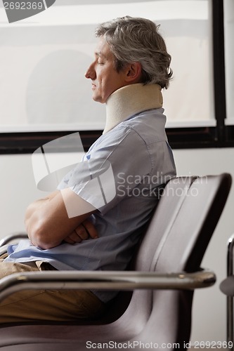 Image of Man With Neck Injury Resting In Lobby