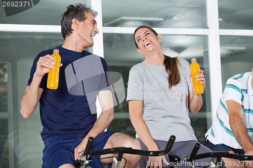 Image of Happy Man And Woman Holding Juice Bottles