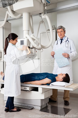 Image of Radiologists With Patient In X-ray Room