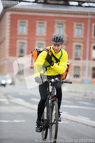 Image of Male Cyclist With Courier Bag Using Walkie-Talkie