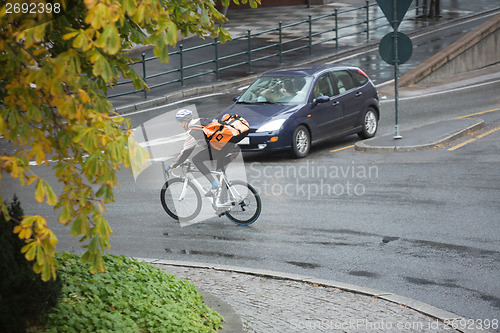 Image of Male Cyclist With Backpack On Street