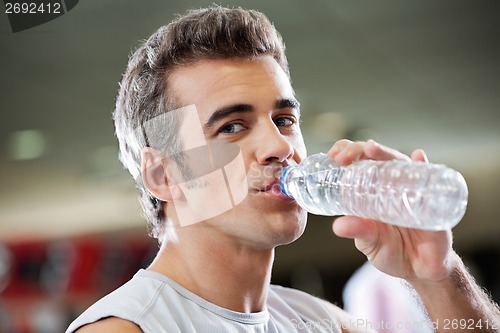 Image of Man Drinking Water From Bottle At Health Club