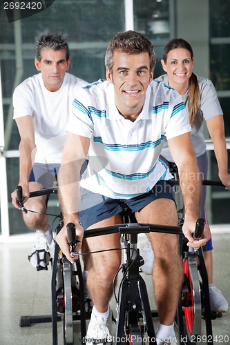 Image of People On Exercise Bikes