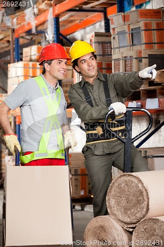 Image of Foreman Showing Something To Coworker At Warehouse