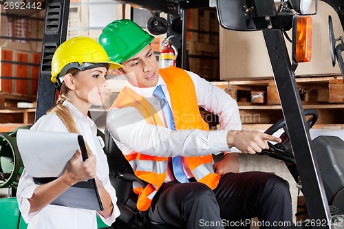 Image of Male Supervisor Showing Something To Colleague At Warehouse