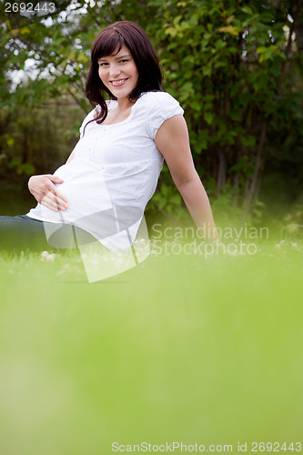 Image of Happy Pregnant Woman in Park