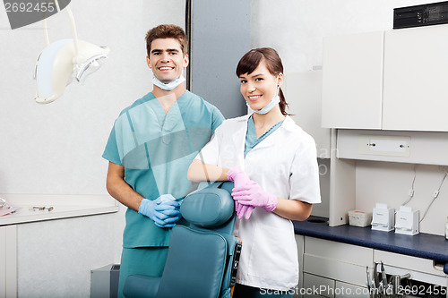 Image of Two Dentists Smiling By Dental Chair At Clinic