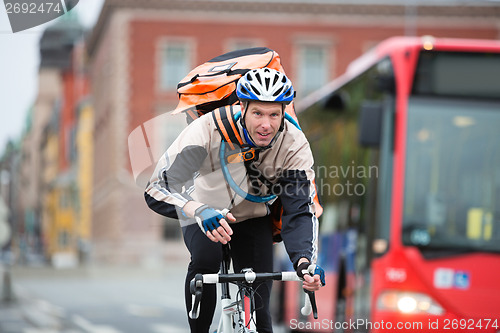 Image of Male Cyclist With Courier Delivery Bag Riding Bicycle