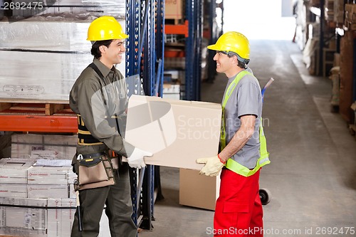 Image of Foremen Carrying Cardboard Box At Warehouse