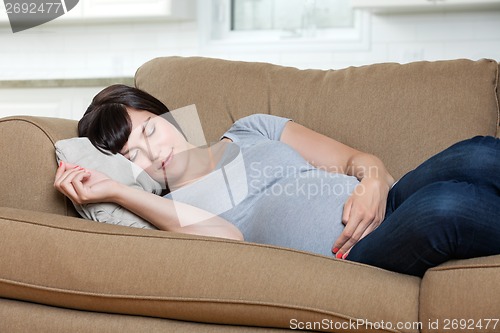 Image of Pregnant Woman Sleeping On Sofa