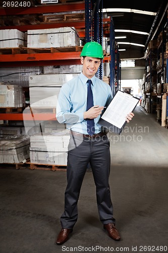 Image of Confident Supervisor Displaying Clipboard